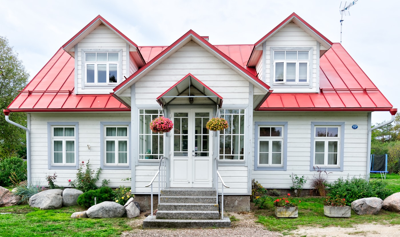 White family home with a red roof